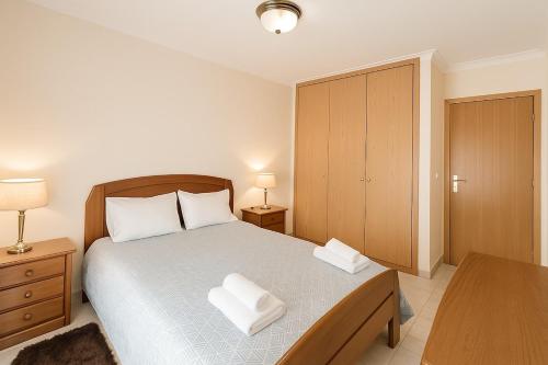 a bedroom with a bed with two pillows on it at 10 min walk to Rocha Beach in Portimão