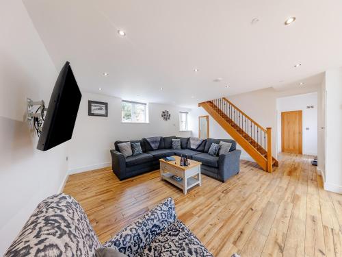 a living room with a couch and a tv at Ty Felin - Uk12744 in Acrefair