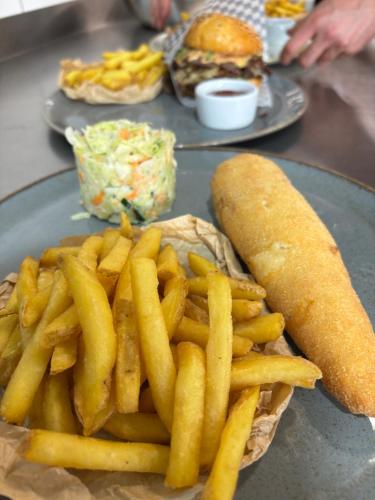 a plate with french fries and a sandwich and a roll at MDS Bonikowo in Bonikowo