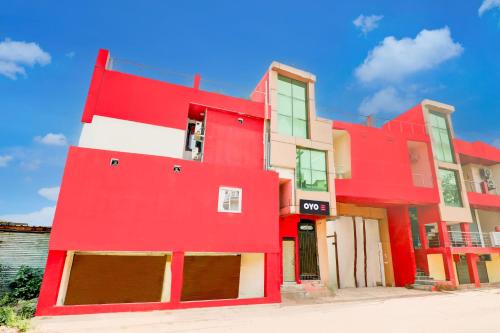 a red and white building on a street at Hotel O Rudra Palace in Nilmatha