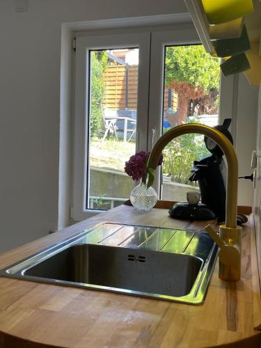 a kitchen sink in a kitchen with a window at Ferienwohnung Utes Stube in Neuwied