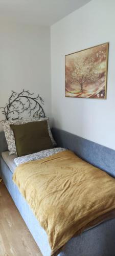 a bedroom with a bed with a picture on the wall at Ursteirerhof - Familie Kerschbaumer in Palsdorf