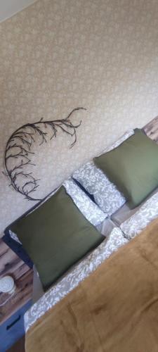 a group of green pillows sitting on a bed at Ursteirerhof - Familie Kerschbaumer in Palsdorf