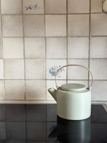 a white tea kettle sitting on top of a stove at Casa Bianca - Strategic location in Bellinzona