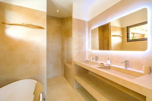a bathroom with a sink and a mirror at Villa Carlina - Saint Tropez in Sainte-Maxime
