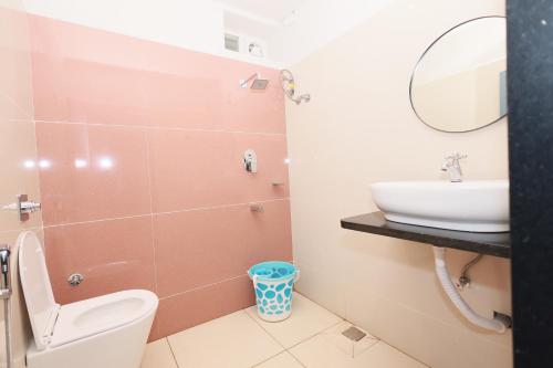 a bathroom with a toilet and a sink at The Lotus Park in Srikalahasti