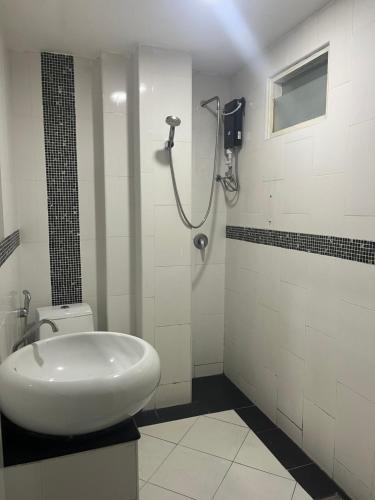 a white bathroom with a shower and a sink at Lagoon vibes in Pattaya Central