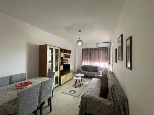 a living room with a couch and a table at KLM Apartments Cozy Stay in Durrës