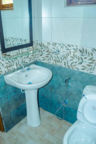 a bathroom with a sink and a toilet at Nimala Holiday Homes in Mihintale