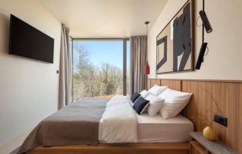 a bedroom with a large bed with a large window at Villa bOX by Villas Guide in Brajkovići