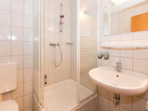 a bathroom with a shower and a sink and a toilet at Pension Landhaus Koller - Adults only in Bodenmais