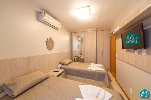 a hospital room with two beds and a tv at Imbassai Solaris - Village 002 in Imbassai