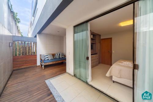 a room with a glass door leading to a bedroom at Imbassai Solaris - Village 002 in Imbassai