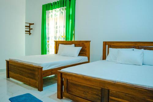 Katil atau katil-katil dalam bilik di Nimala Holiday Homes