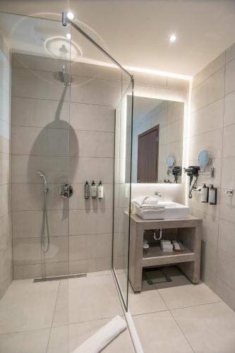 a bathroom with a shower and a sink at IRA - ΗΡΑ Hotel in Kalamata