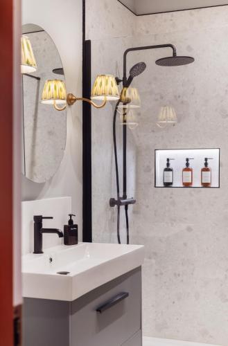 a bathroom with a sink and a shower and a mirror at The Castle in Newcastle