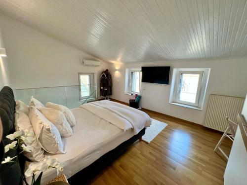 a bedroom with a bed and a flat screen tv at Saint George Cottage in Avyenikí