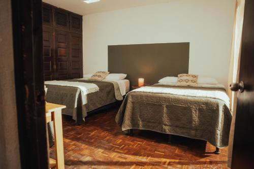 a room with two beds in a room at Central Hostel Metro10 in Guatemala