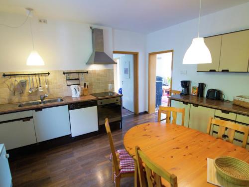 a kitchen and dining room with a wooden table at Geräumiges Ferienhaus in Hessen mit Garten in Waldeck