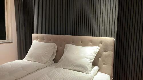a white bed with two pillows in a room at Maison Nord, 6 min from Airport & Sleep 5 in Copenhagen