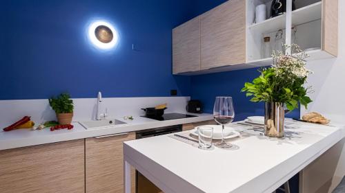 a kitchen with blue walls and a white counter top at Italianway - Porta Ticinese 78 B in Milan