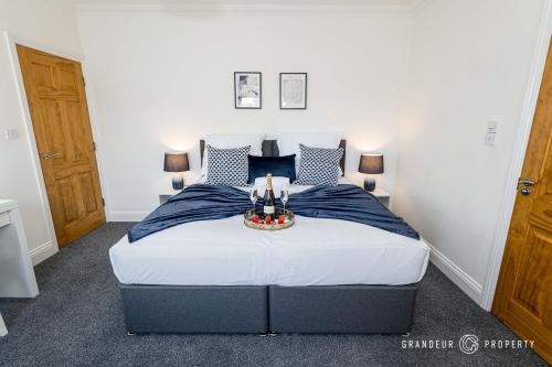a bedroom with a large bed with a table on it at The Westborough Nook by Grandeur Property in Wimborne Minster