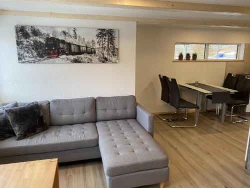 a living room with a couch and a table at Retreat with Private Garden in Güntersberge