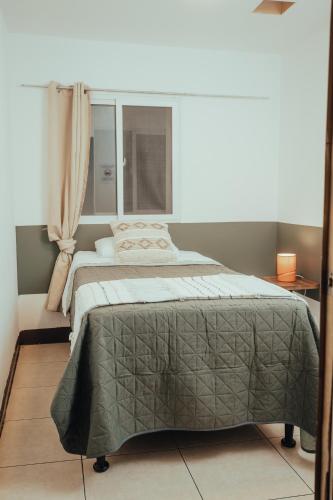 a bedroom with a bed and a window at Central Hostel Metro10 in Guatemala
