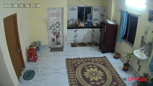 a bathroom with a sink and a rug on the floor at Ghosh homestay 8 in kolkata