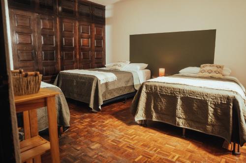 a room with two beds in a room at Central Hostel Metro10 in Guatemala