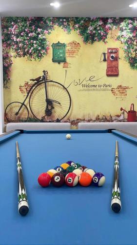 a ping pong table with balls in front of a bike at Cobalt House in Ðông Thôn