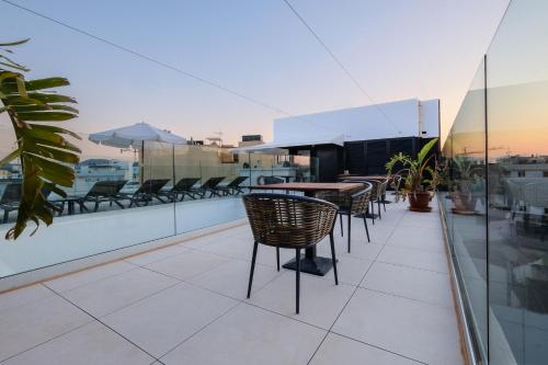 a balcony with chairs and tables on a building at M. HOTEL in San Antonio