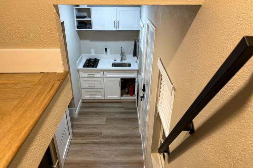 a small kitchen with a sink and a hallway at Perris Paradise in Perris