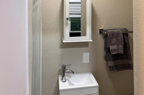a bathroom with a sink and a mirror at Perris Paradise in Perris