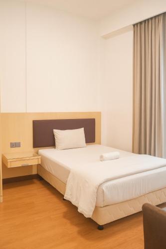 a bedroom with a large white bed in a room at Imperial Suites Apartment Kuching in Kuching