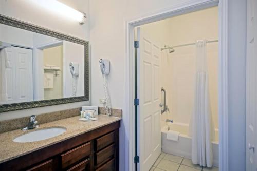 a bathroom with a sink and a shower at Staybridge Suites Rockford by IHG in Rockford
