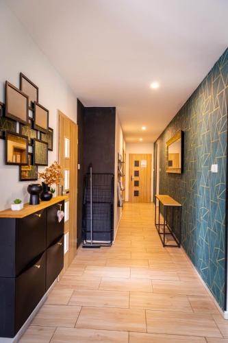 a hallway of a house with wooden floors and black cabinets at Holiday House Valaliky in Valaliky