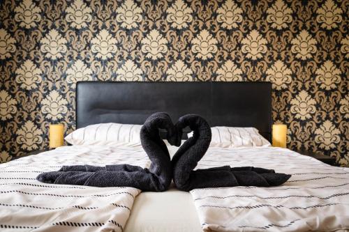 two swans making a heart shape on a bed at Holiday House Valaliky in Valaliky