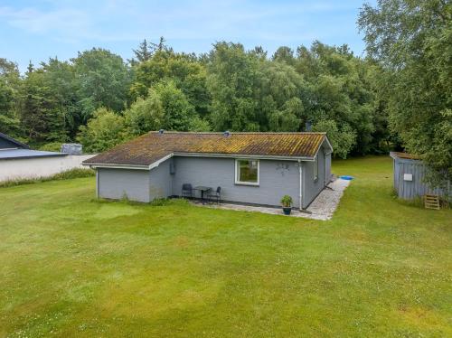 a small house in a field with a yard at Cozy Holiday Home 350 Meters From The Water In Amtoft in Vesløs