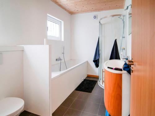 a bathroom with a tub and a toilet and a sink at Halfway between near Nature Park in Jalhay