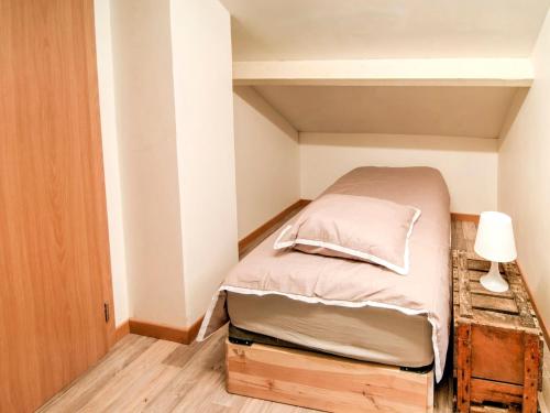 a small bedroom with a bed in a small room at Halfway between near Nature Park in Jalhay