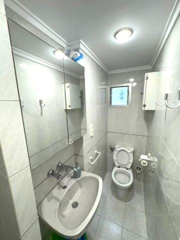 a bathroom with a sink and a toilet at 1st Line Beach Direct Access Private Parking in Valencia