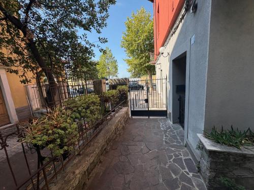 a walkway leading to a building with a gate at Il Giardino Nascosto in Trieste