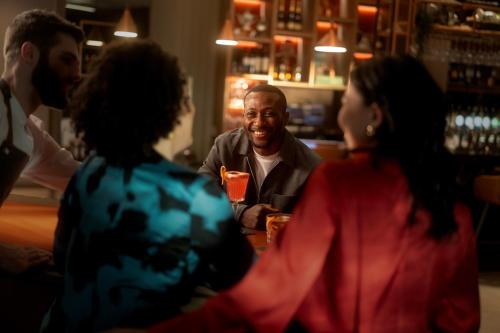 a group of people sitting around a table in a bar at Clayton Hotel Bristol City in Bristol