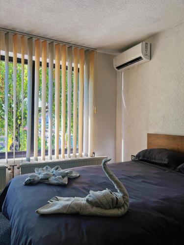 a bedroom with a bed with a towel on it at Apartman Alinac in Cazin