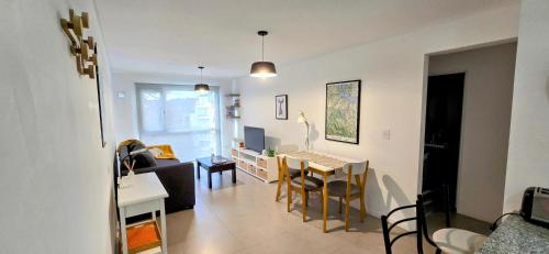 una sala de estar con un sofá y una mesa en Departamento céntrico Pioneros y Campichuelo, en San Carlos de Bariloche