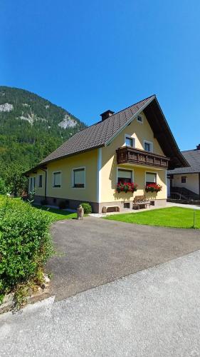 a large yellow house with a black roof at Ferienhaus Akogelblick in Landl