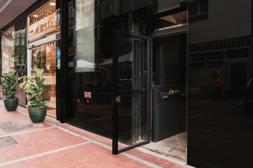 an open door of a store on a street at Hotel Aloe Canteras in Las Palmas de Gran Canaria