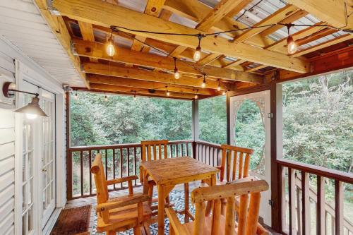 a porch with a wooden table and two chairs at Laurel Creek in Helen