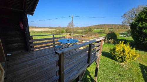 a wooden deck with a table on top of it at Appartement de Charme in Baugé-en-Anjou